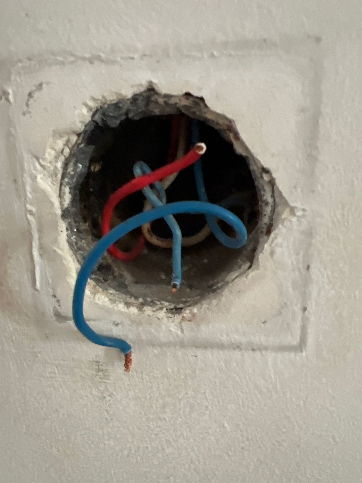 Artistic wall hole with colorful electrical wires